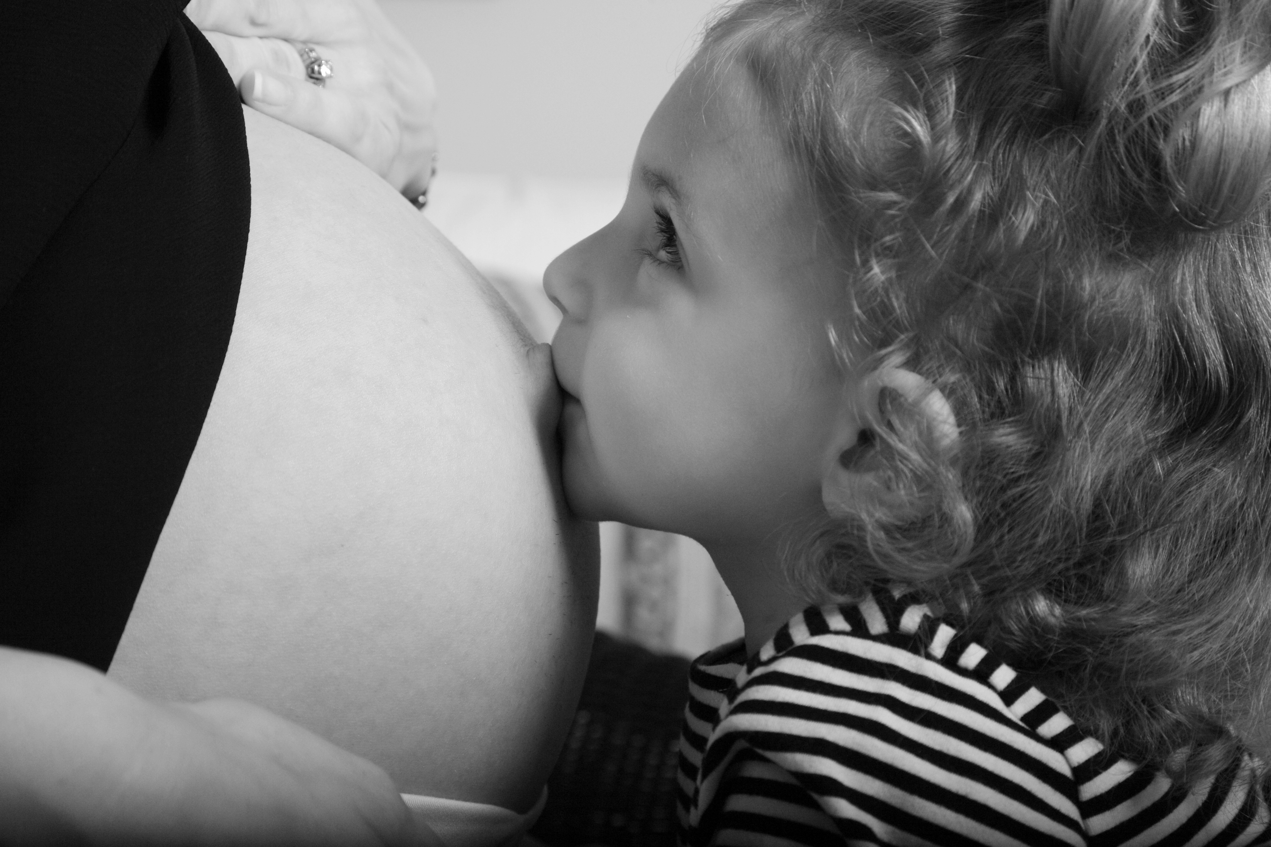Child kissing belly